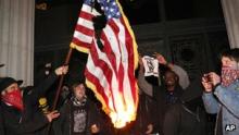 Protesters burned the US flag outside Oakland's City Hall