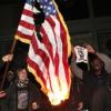 Protesters burned the US flag outside Oakland's City Hall